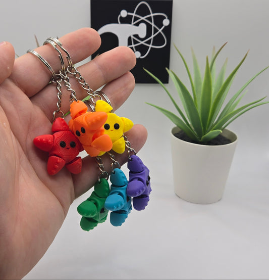 mini articulated starfish on keychains with plants and the crafticist logo in the background