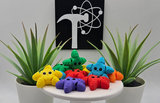 colorful articulated starfish on a white pedestal with two plants and the Crafticist logo in the background.